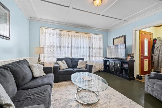 a living room with furniture a couch and large windows