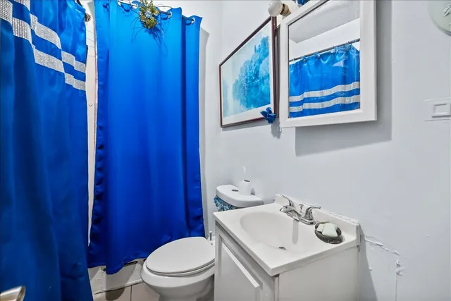 a bathroom with a sink mirror and toilet