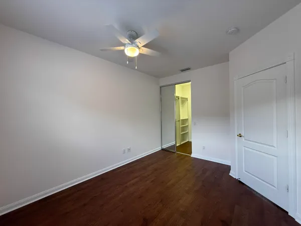 an empty room with wooden floor and a window