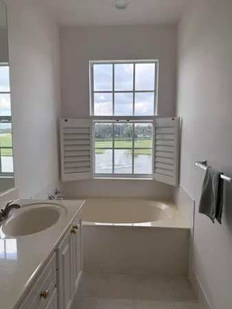 a bath tub sitting in a bathroom next to a window