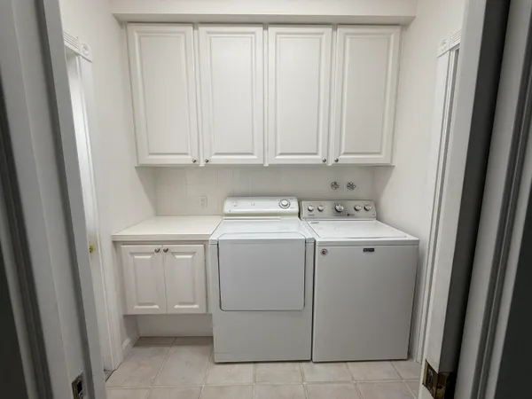 a white toilet sitting next to a sink and a mirror