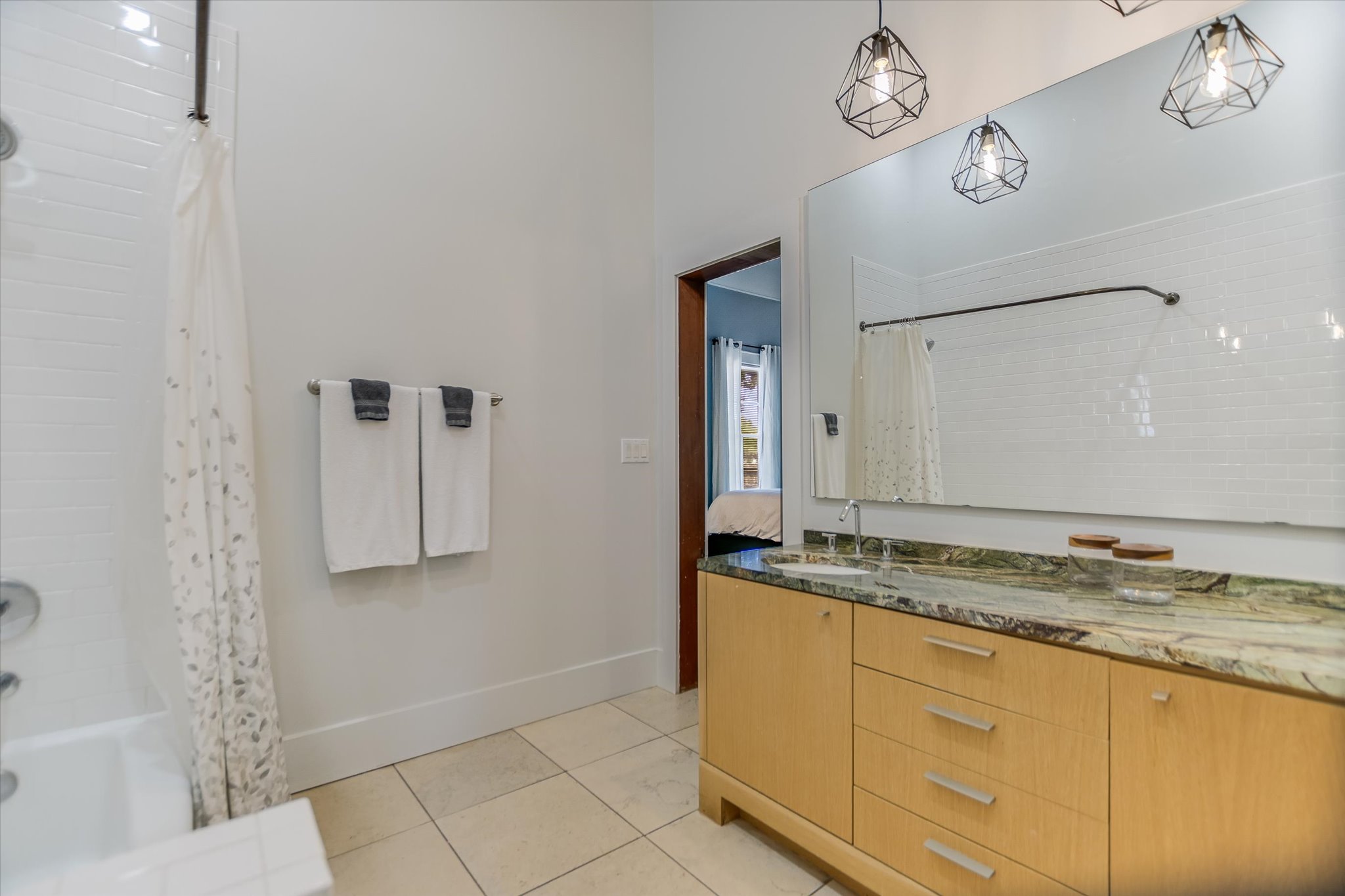2109 Nickerson Street Austin, TX 78704 - Photo 16 of 23 a bathroom with a granite countertop sink a mirror and shower