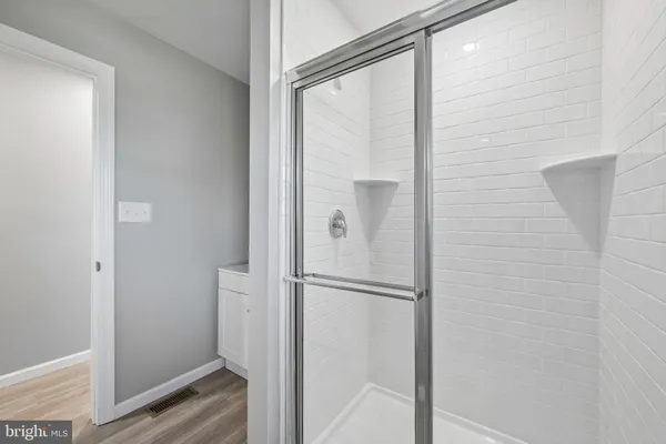 a bathroom with a glass shower door
