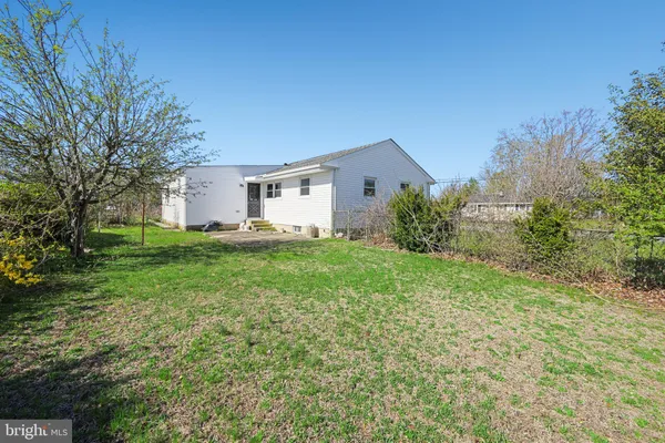 a view of a house with yard and a tree