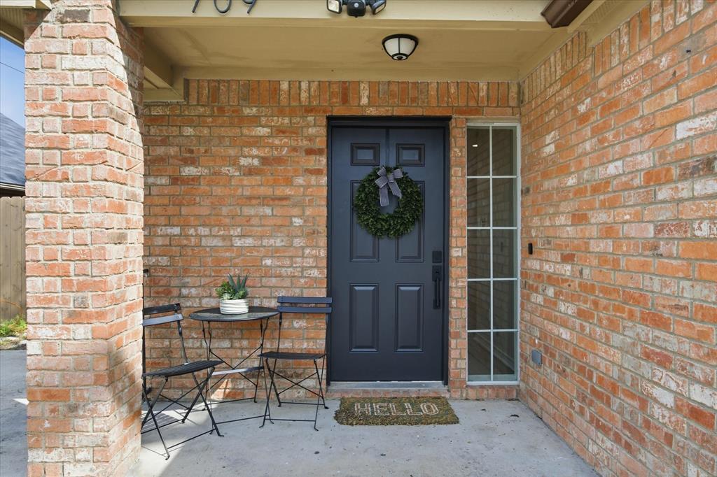 709 Sherman Street Rockwall, TX 75087 - Photo 16 of 23 a brick building with a door and a chair