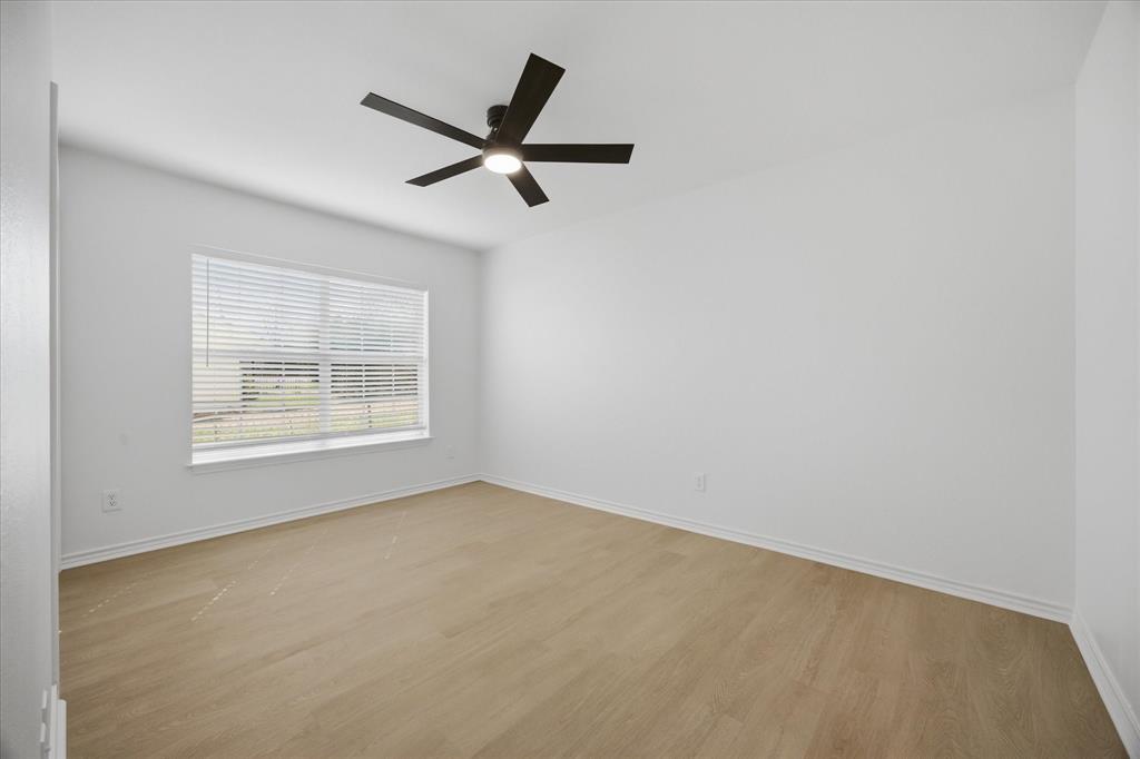 709 Sherman Street Rockwall, TX 75087 - Photo 23 of 23 an empty room with a window and a fan
