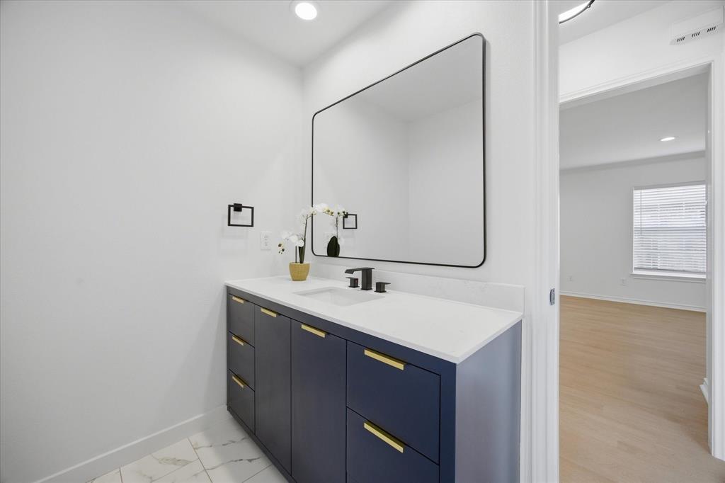 709 Sherman Street Rockwall, TX 75087 - Photo 9 of 23 a bathroom with a sink and a mirror