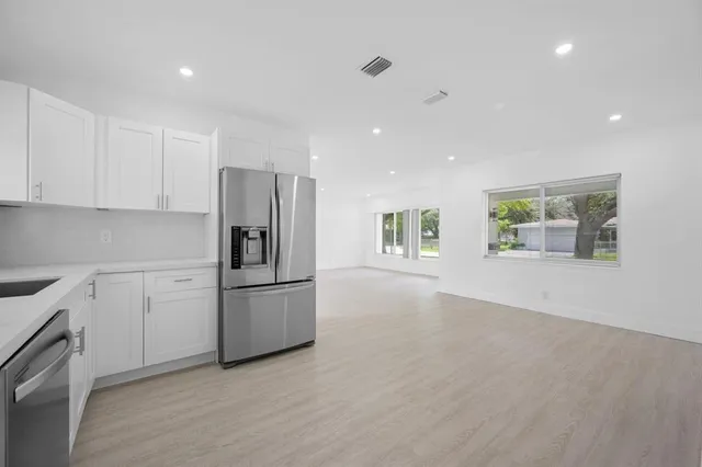 a kitchen with a refrigerator stove and cabinets