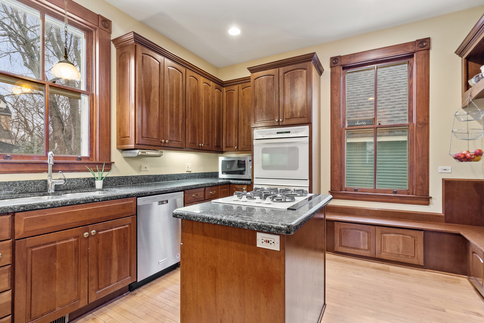 1333 Church Street Evanston, IL 60201 - Photo 15 of 32 a kitchen with kitchen island granite countertop a sink stove and cabinets