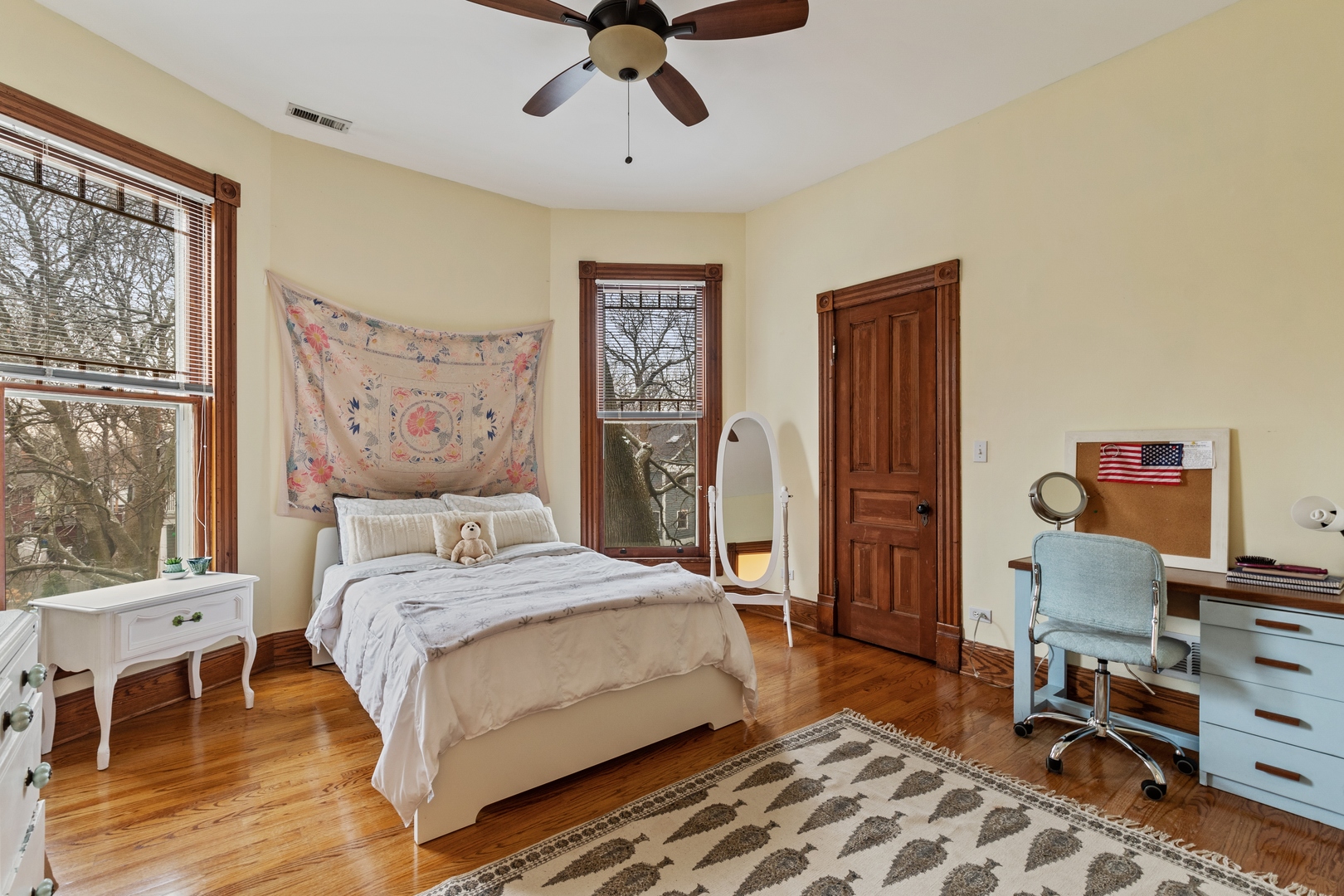 1333 Church Street Evanston, IL 60201 - Photo 22 of 32 a bedroom with a bed a desk and chair with wooden floor