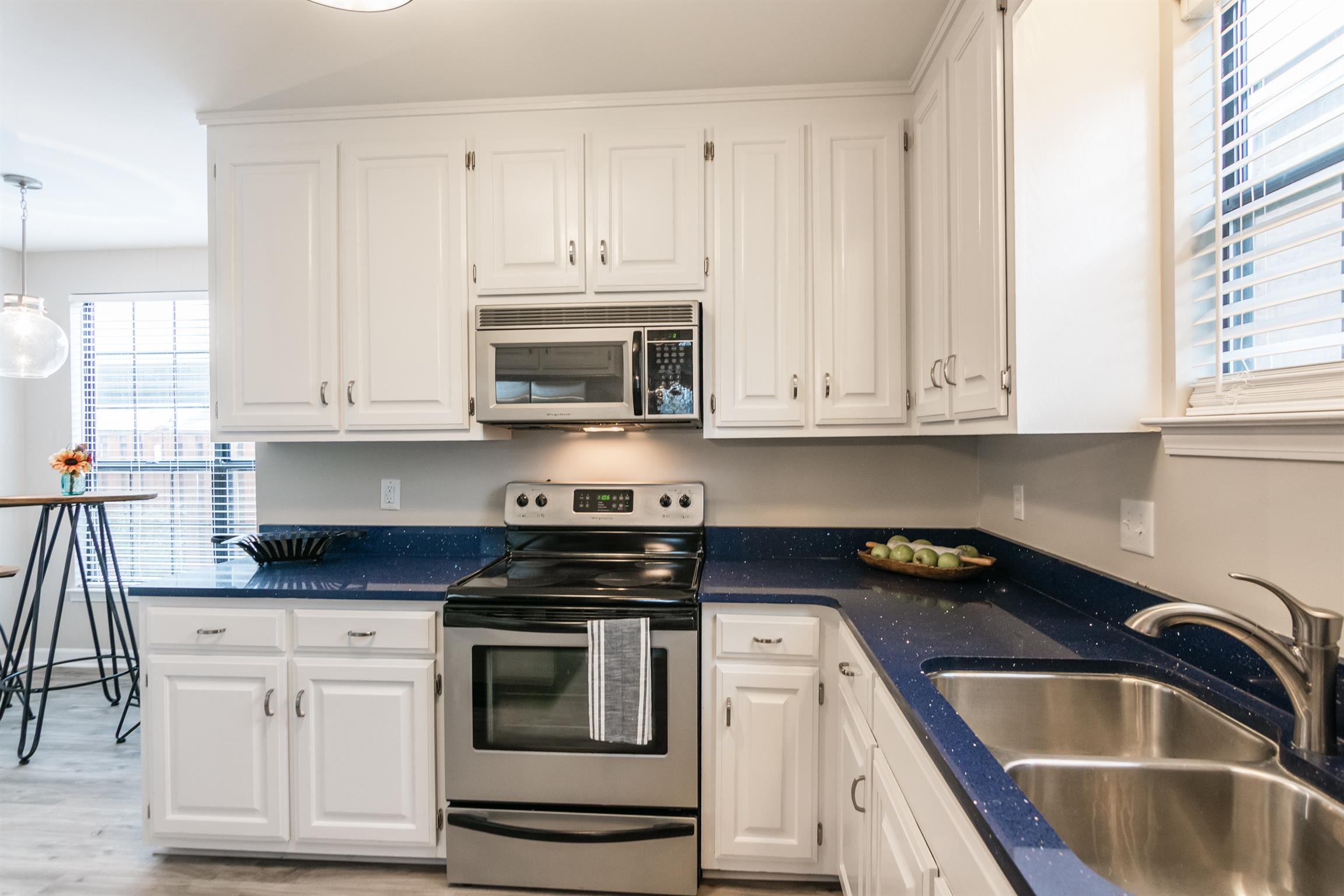 701 General George Patton Road Nashville, TN 37221 - Photo 8 of 27 a kitchen with granite countertop white cabinets and stainless steel appliances