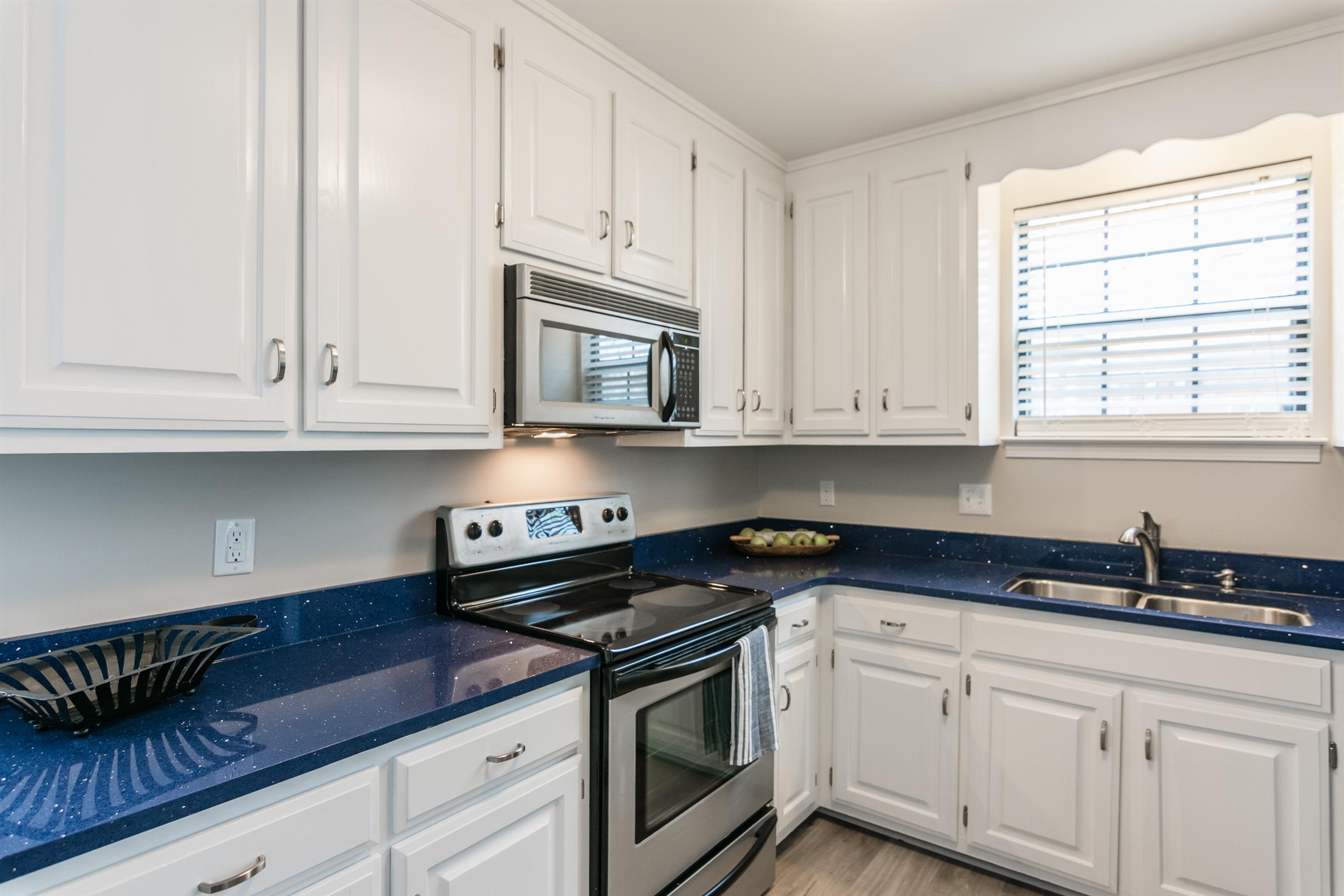 701 General George Patton Road Nashville, TN 37221 - Photo 10 of 27 a kitchen with granite countertop white cabinets and a stove