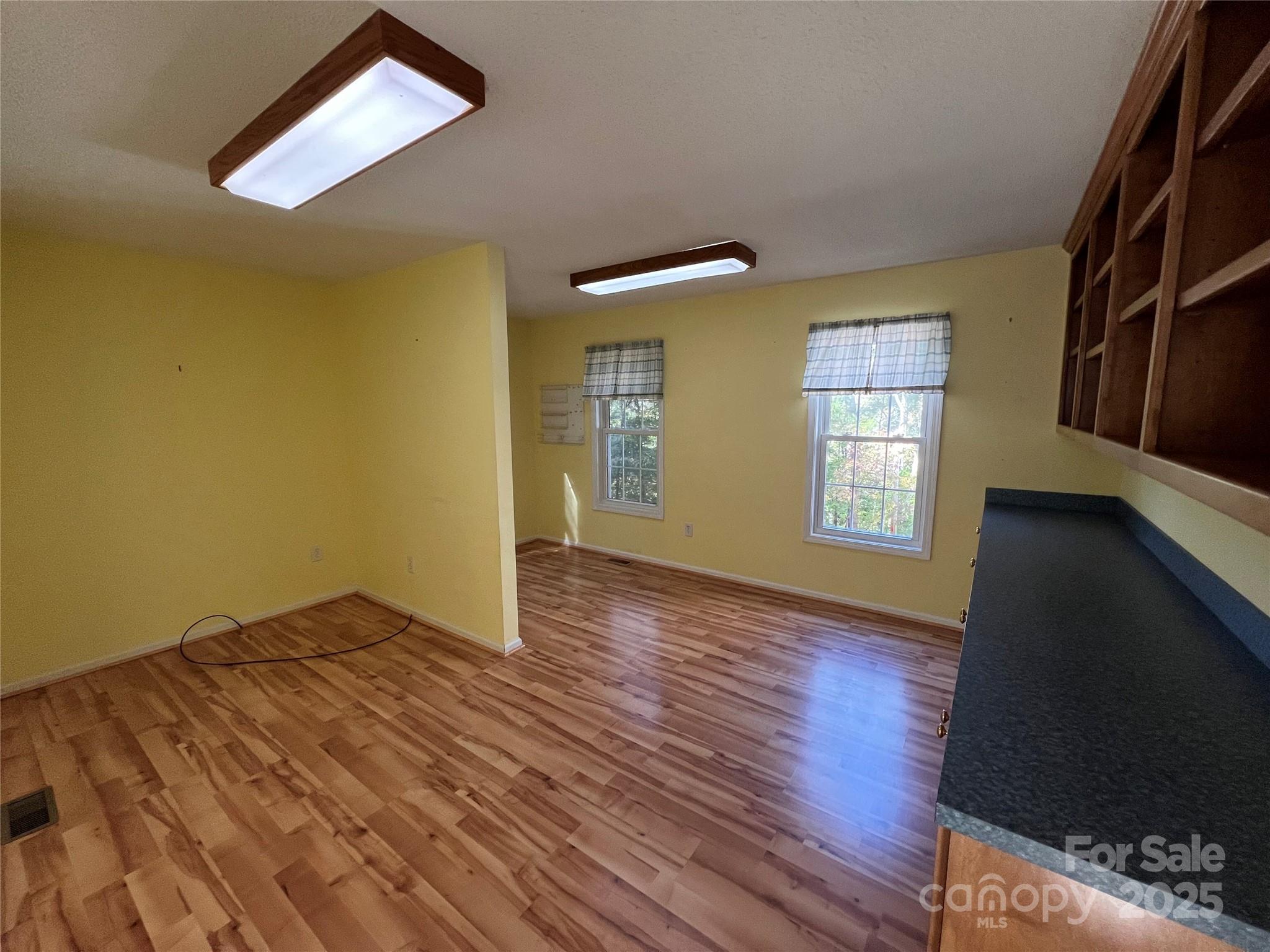 25397 Stony Mountain Road Albemarle, NC 28001 - Photo 16 of 32 wooden floor in an empty room with a window