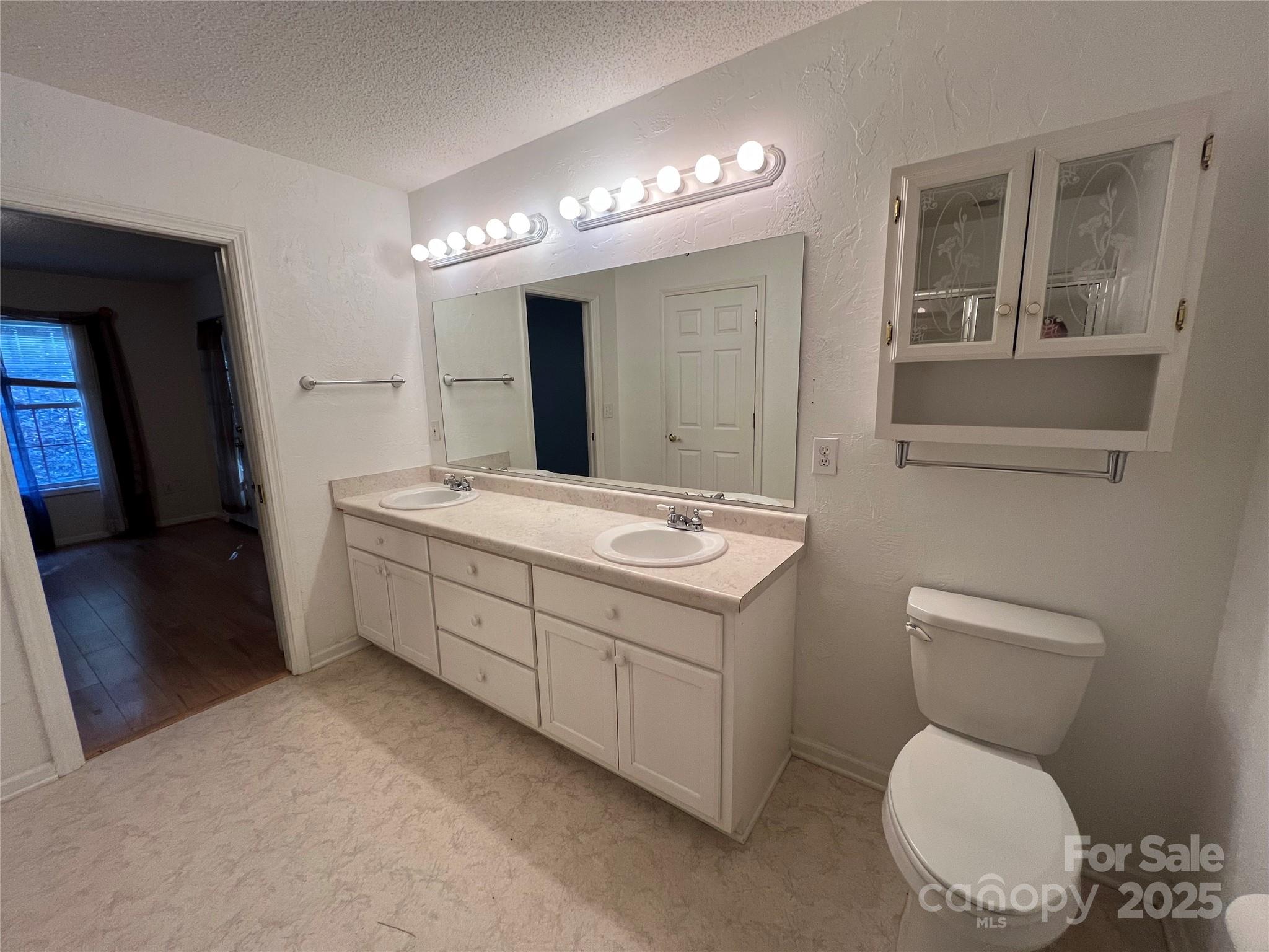 25397 Stony Mountain Road Albemarle, NC 28001 - Photo 20 of 32 a bathroom with a toilet sink and mirror