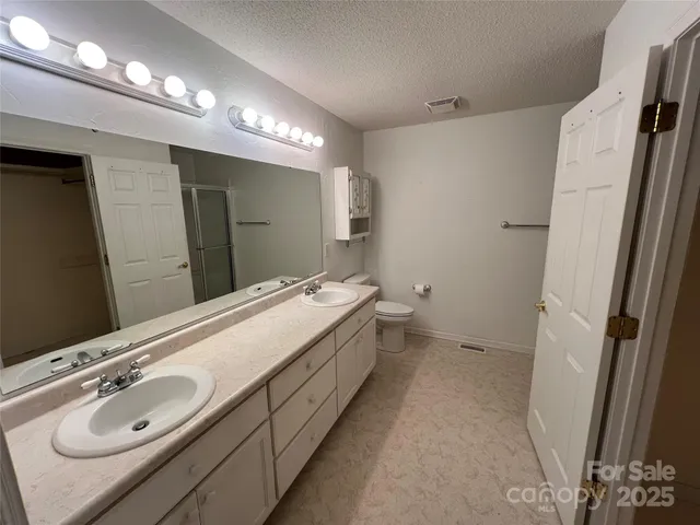 a bathroom with a double vanity sink and mirror