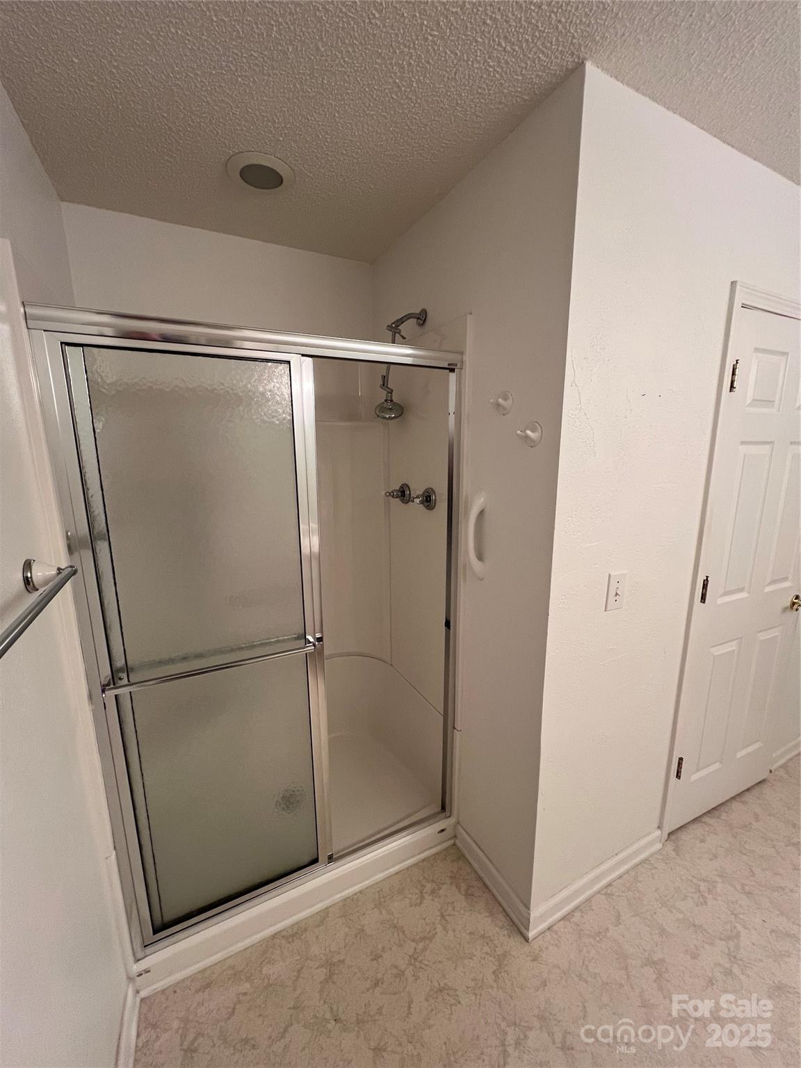 25397 Stony Mountain Road Albemarle, NC 28001 - Photo 22 of 32 a bathroom with a glass shower door