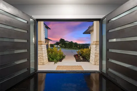 a kitchen with stainless steel appliances granite countertop a sink a stove and a wooden floors