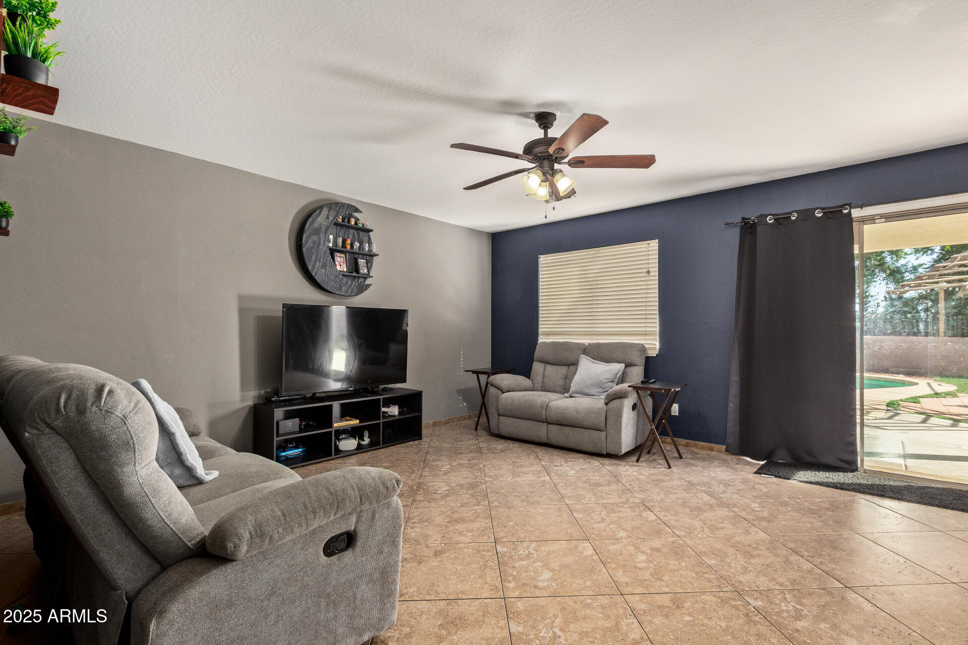 8517 West Riley Road Tolleson, AZ 85353 - Photo 3 of 42 a living room with furniture and a flat screen tv