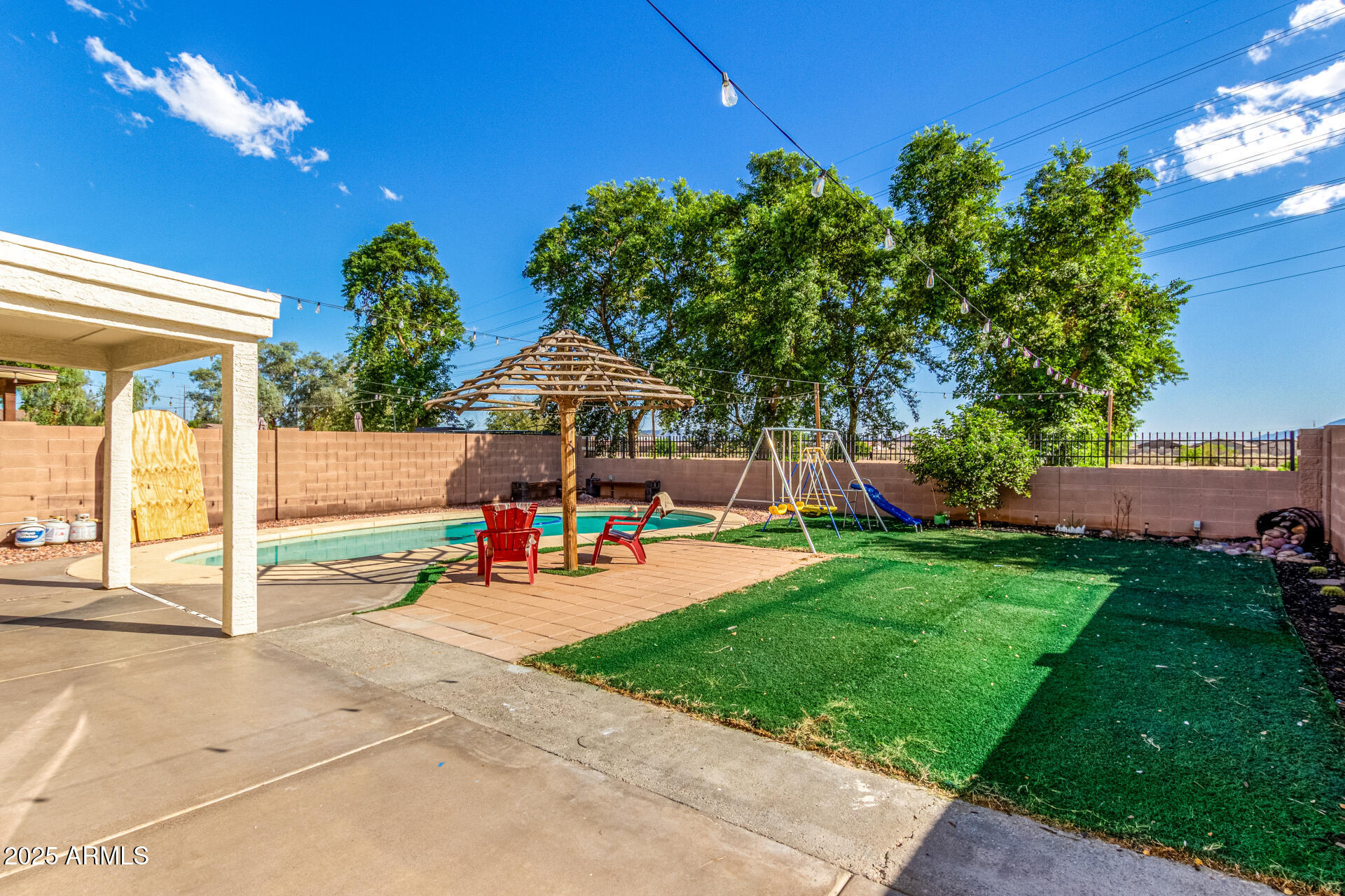 8517 West Riley Road Tolleson, AZ 85353 - Photo 36 of 42 a view of a backyard with plants and chairs