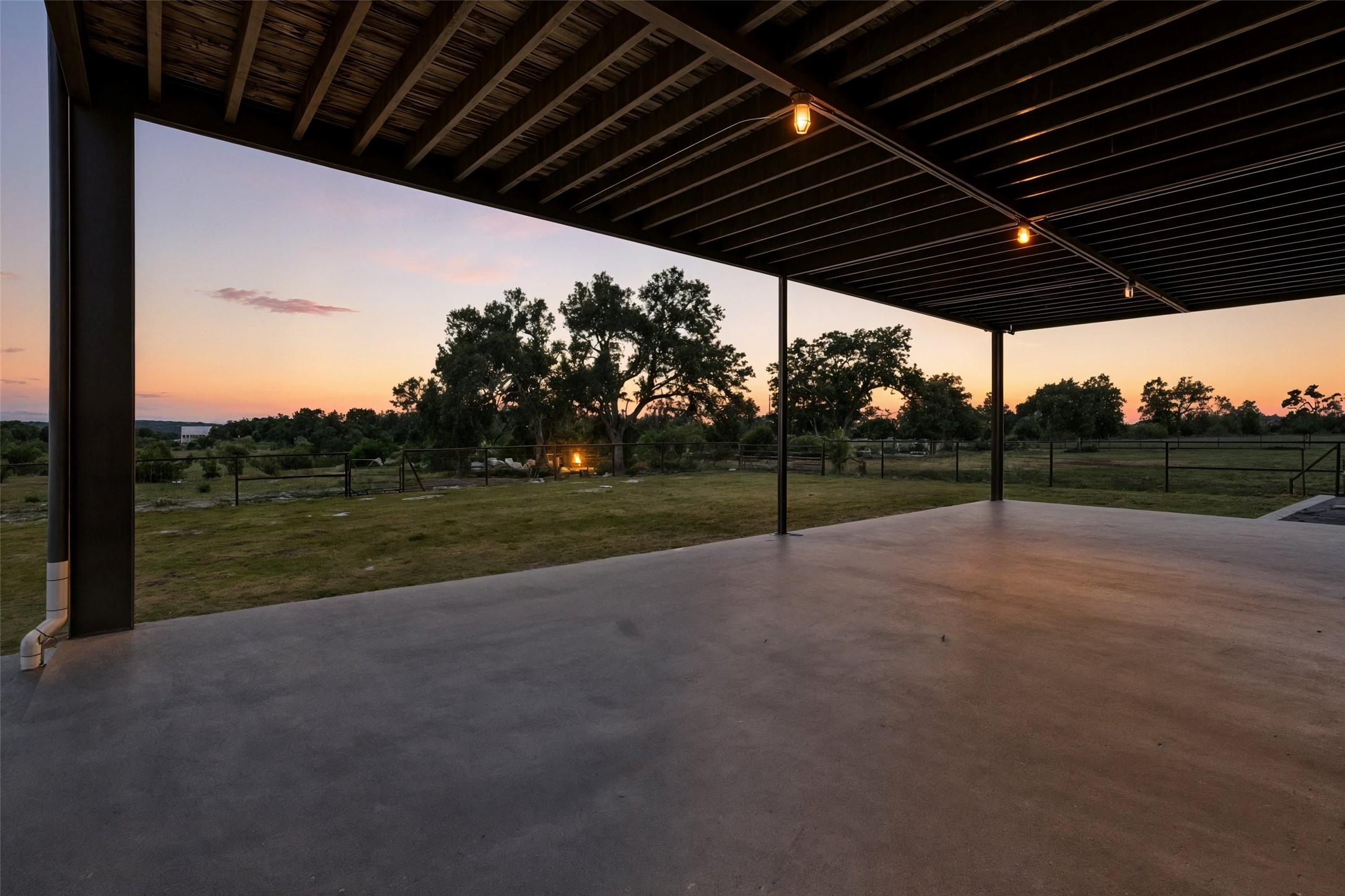 561 Broken Bit Trail Dripping Springs, TX 78620 - Photo 5 of 40 Patio terrace at dusk featuring a fenced backyard and a patio