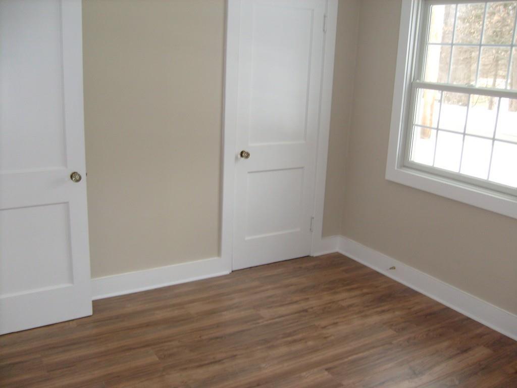 49 Birch Meadow Road Merrimac, MA 01860 - Photo 23 of 27 an empty room with wooden floor and windows