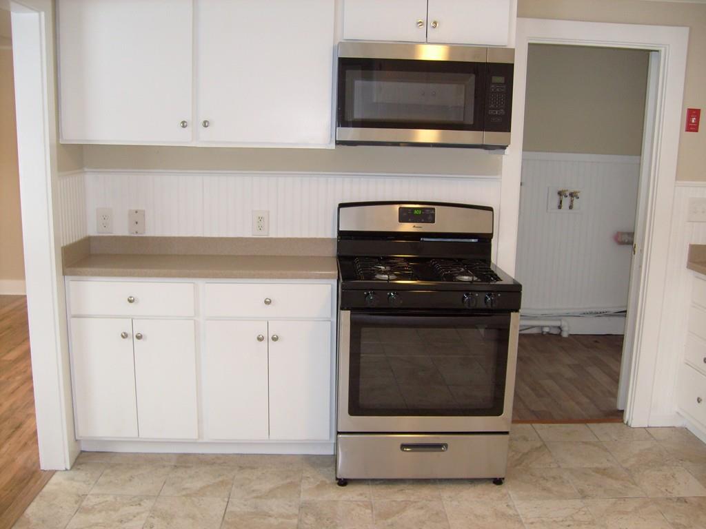 49 Birch Meadow Road Merrimac, MA 01860 - Photo 6 of 27 a kitchen with stainless steel appliances a stove and a microwave