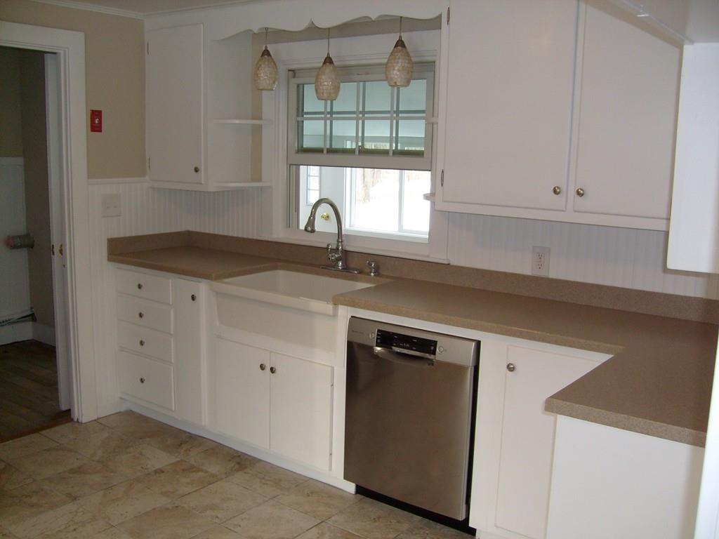 49 Birch Meadow Road Merrimac, MA 01860 - Photo 7 of 27 a kitchen with granite countertop white cabinets and a window