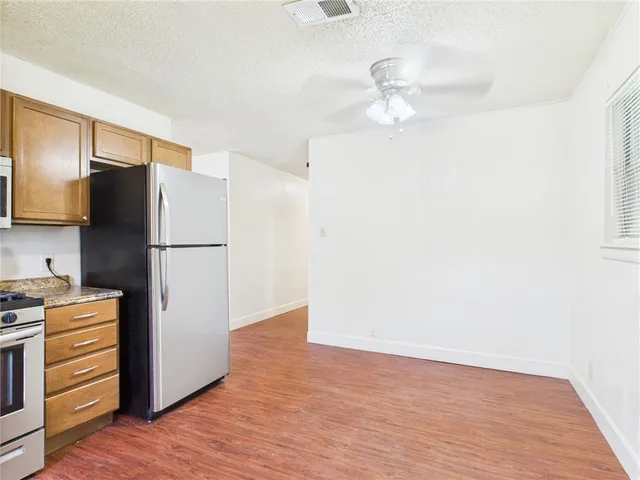 a view of a room with wooden floor and brick wall