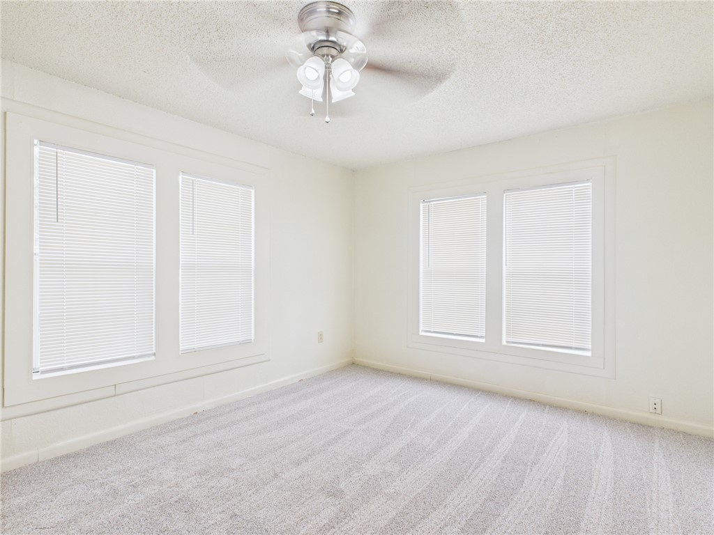 2702 Cavitt Avenue Bryan, TX 77801 - Photo 20 of 21 Carpeted spare room with a textured ceiling and a ceiling fan
