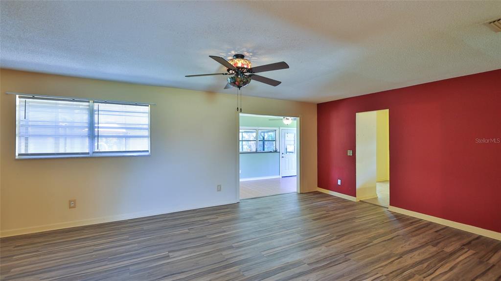 725 Green Road New Smyrna Beach, FL 32168 - Photo 15 of 40 wooden floor in an empty room with a window