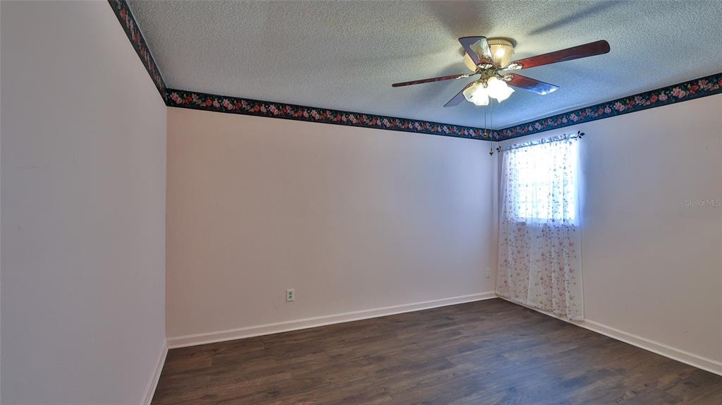 725 Green Road New Smyrna Beach, FL 32168 - Photo 18 of 40 a view of a livingroom with a window and a chandelier