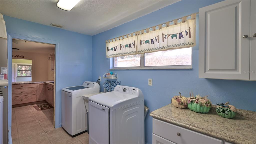 725 Green Road New Smyrna Beach, FL 32168 - Photo 20 of 40 a utility room with faucet washer and dryer