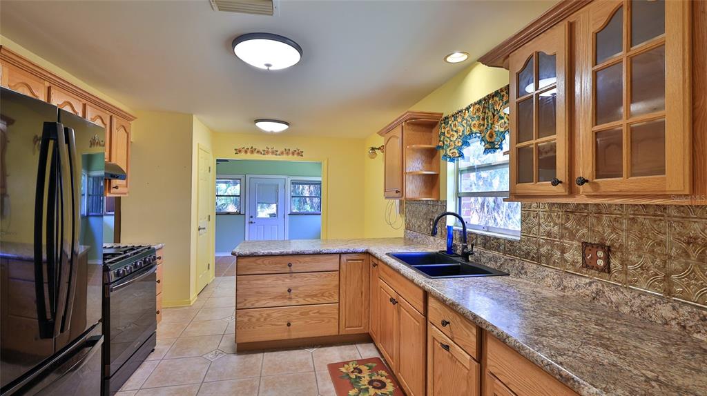725 Green Road New Smyrna Beach, FL 32168 - Photo 22 of 40 a kitchen with a refrigerator and a sink