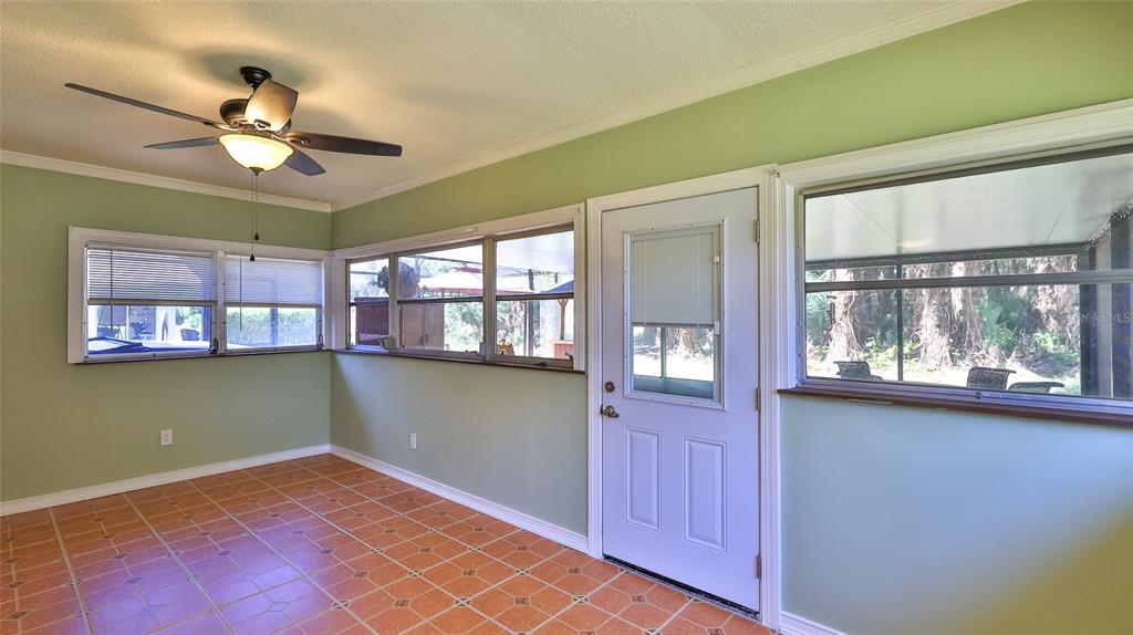725 Green Road New Smyrna Beach, FL 32168 - Photo 27 of 40 a view of a livingroom with a ceiling fan and window