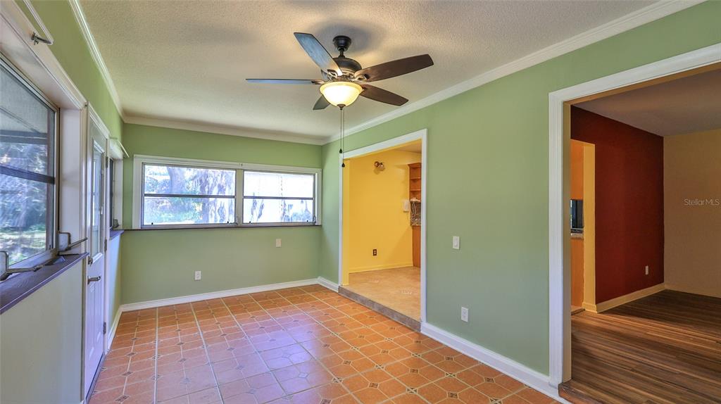 725 Green Road New Smyrna Beach, FL 32168 - Photo 28 of 40 a view of a livingroom with a ceiling fan & windows