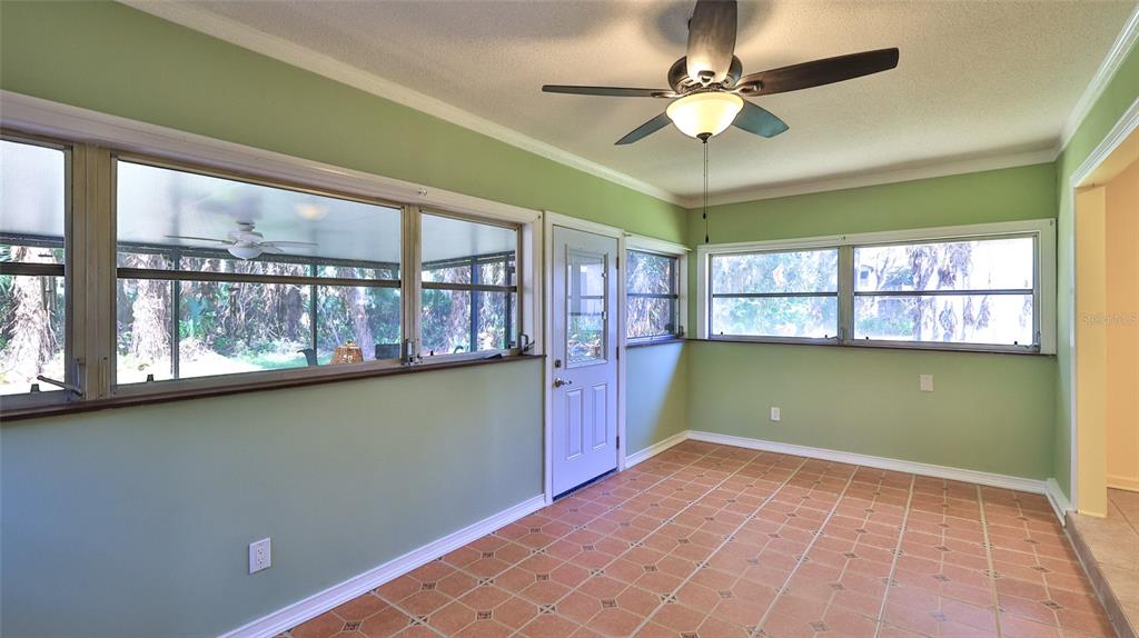 725 Green Road New Smyrna Beach, FL 32168 - Photo 29 of 40 a view of an empty room with a window and a ceiling fan