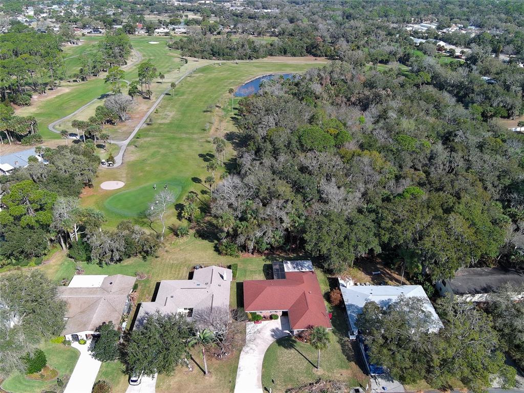 725 Green Road New Smyrna Beach, FL 32168 - Photo 34 of 40 an aerial view of a house with a garden