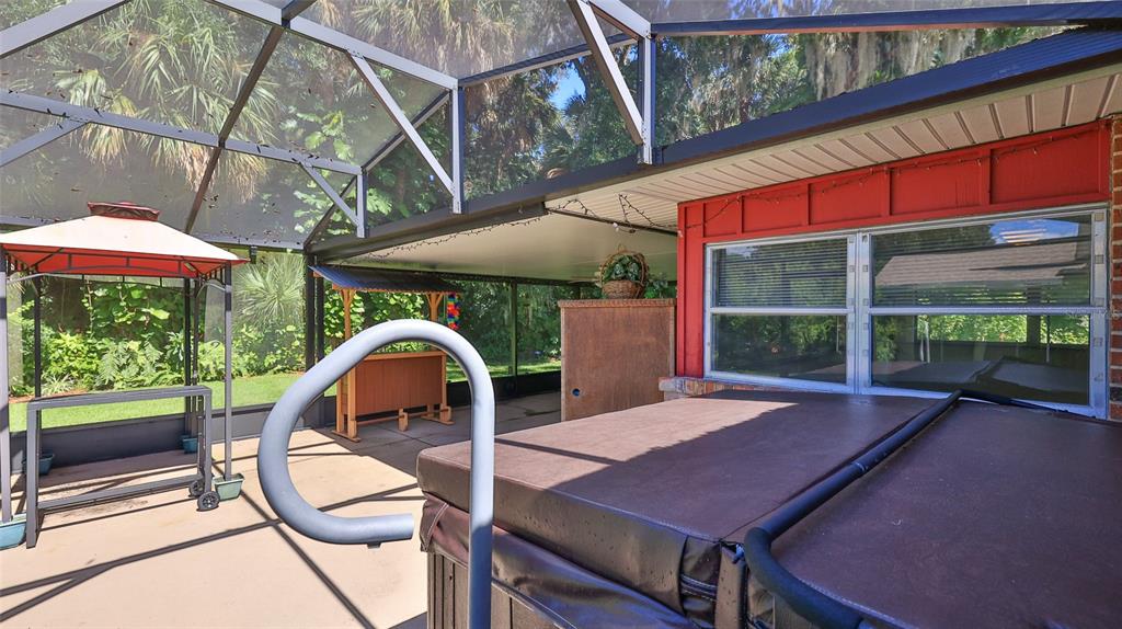 725 Green Road New Smyrna Beach, FL 32168 - Photo 4 of 40 a backyard of a house with table and chairs