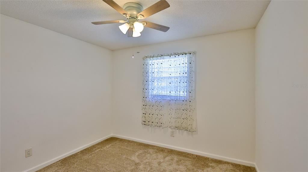 725 Green Road New Smyrna Beach, FL 32168 - Photo 8 of 40 an empty room with windows