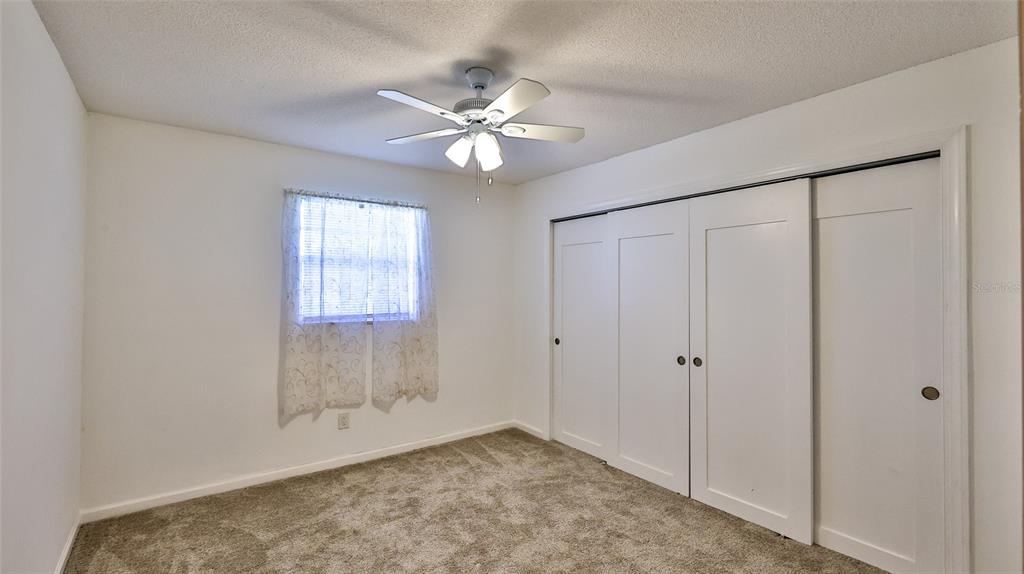 725 Green Road New Smyrna Beach, FL 32168 - Photo 9 of 40 a view of an empty room with chandelier fan