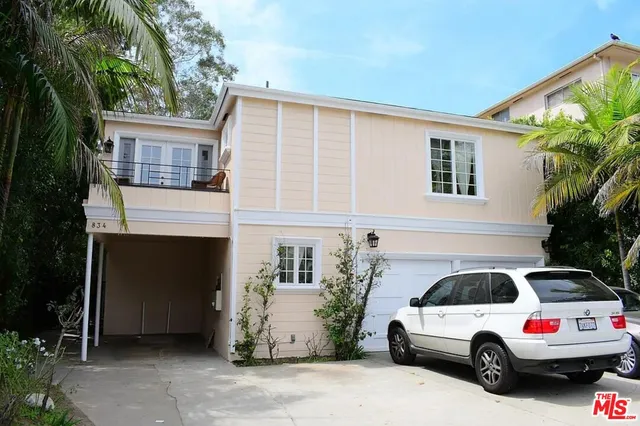 a front view of a house with parking space