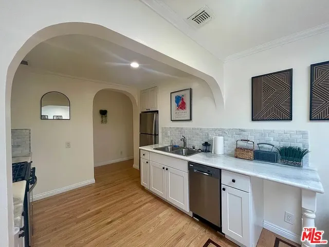 a spacious bathroom with a granite countertop sink mirror and vanity