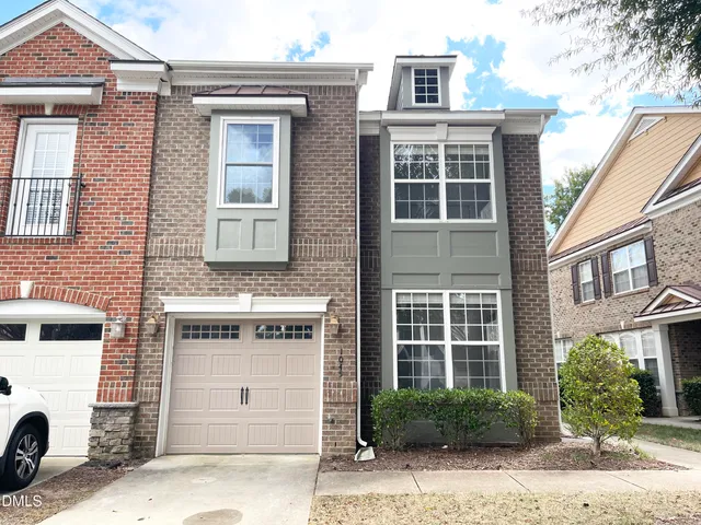 a front view of a building with a garden