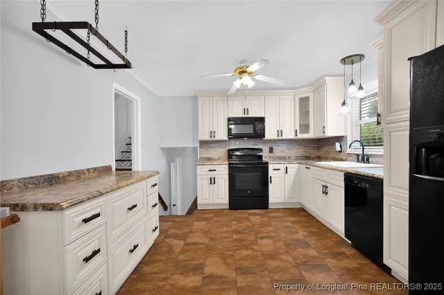 a kitchen with kitchen island a sink appliances and cabinets