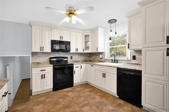 a kitchen with a stove a sink and a microwave