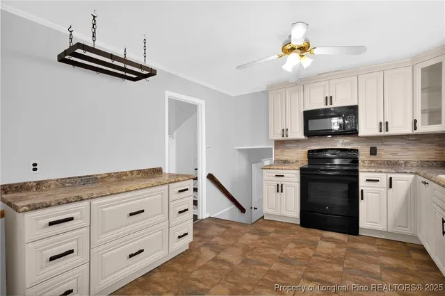 a kitchen with granite countertop a stove top oven a sink a counter space and cabinets