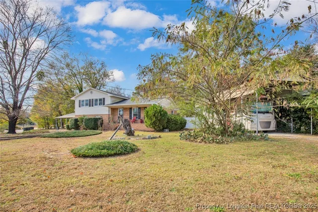 a view of a house with a yard covered in snow