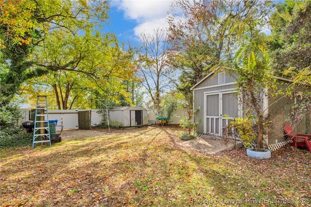 a backyard of a house with table and chairs