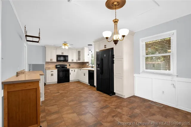 a kitchen with stainless steel appliances granite countertop a refrigerator a stove a sink dishwasher and a refrigerator with wooden floor