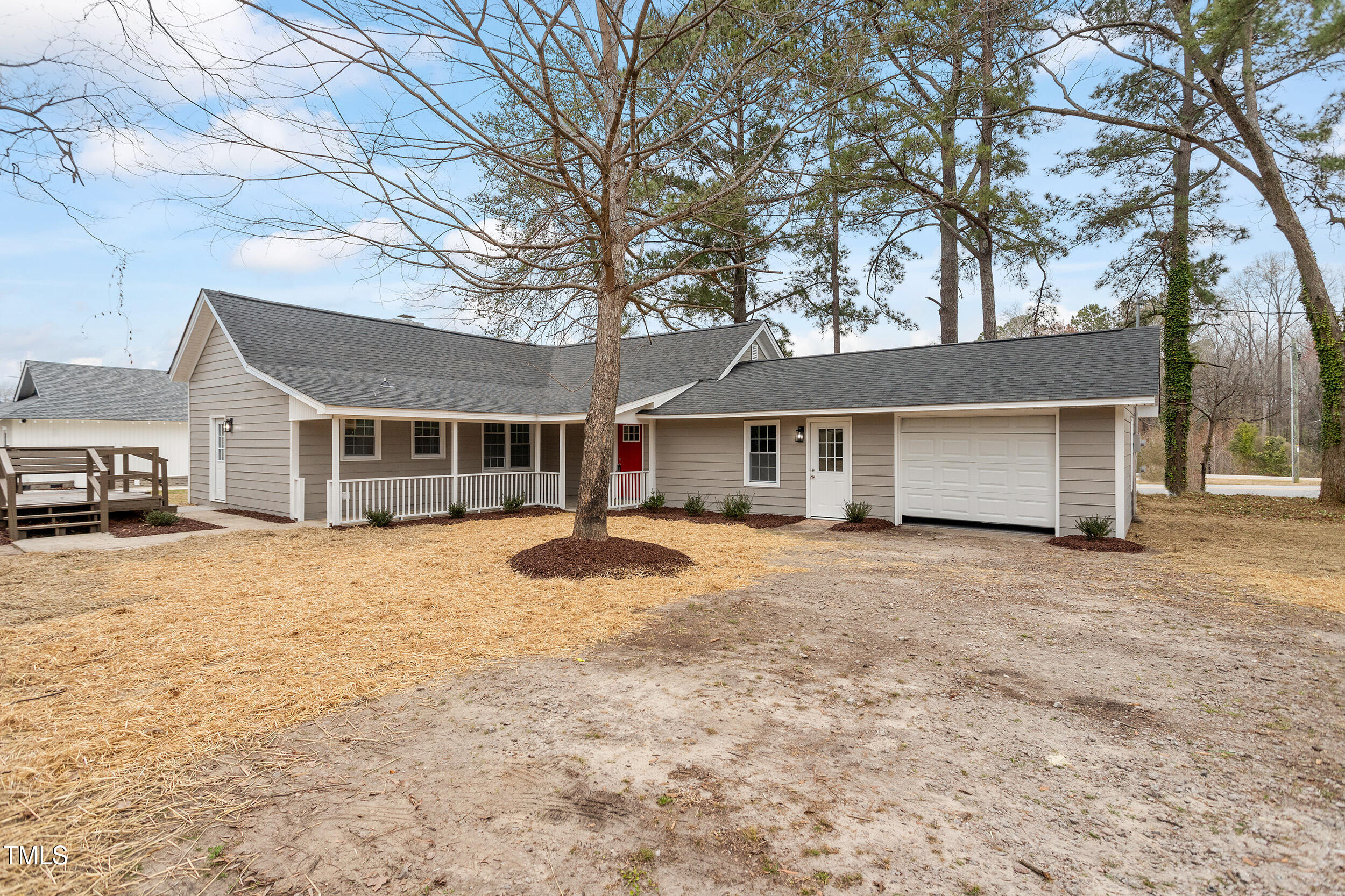 a front view of a house with a yard and trees